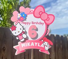 a hello kitty birthday sign with the number six on it