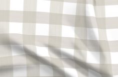 a white and beige checkered fabric with a ruler in the foreground to scale