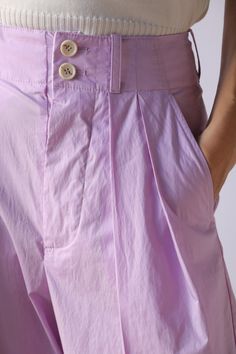 Sale items are final sale. No returns or exchanges. Expertly crafted from soft cotton, these pleated lilac pants feature a high rise and double pleats, providing both comfort and style. The white button fastening closure and belt loops add functional details, while the side slip pockets and back buttoned pockets add a touch of practicality. Perfect for any occasion. Need further assistance? Text our stylists for more details about fit, fabrication, photos etc! Relaxed fit, we suggest ordering a Purple Pleated Bottoms For Spring, Summer Pleated Purple Bottoms, Summer Purple Pleated Bottoms, Lavender Wide Leg Cotton Bottoms, Purple Cotton Bottoms For Daywear, Purple Cotton Bottoms With Belt Loops, Spring Lavender Relaxed Fit Bottoms, Chic Pleated Purple Bottoms, Lavender Wide-leg Bottoms For Summer