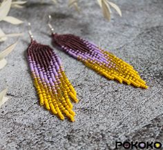 "These purple yellow beaded earrings pair amazingly with any outfit, dressy or casual. They will emphasize your individuality and compliment your personality on various occasions. Perfect for looking pulled together and on trend. They are made of high-quality Czech colored beads with sterling silver hooks and silicone plugs. Colors: shining purple, purple, shining yellow, yellow. Length: 4 inches (10.5 cm) Width: 0.8 inches (2 cm) Materials:     Czech \"Preciosa\" beads     Durable synthetic thread     Sterling silver ear hooks     Silicone plugs If you are on the hunt for a gift that will show your significant other some love, these picks are a great solution to surprise and delight. I hope you can find everything here that you were looking for. If you have any questions related to earrin Yellow Beaded Bohemian Chandelier Earrings, Bohemian Yellow Beaded Chandelier Earrings, Yellow Beaded Drop Earrings With Dangling Beads, Yellow Beaded Chandelier Drop Earrings, Yellow Beaded Fringe Earrings With Round Beads, Yellow Beaded Dangle Chandelier Earrings, Yellow Bohemian Beaded Earrings With Gold Beads, Bohemian Yellow Beaded Earrings With Gold Beads, Yellow Chandelier Drop Earrings With Dangling Beads