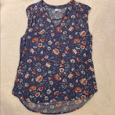 a blue top with red and white flowers on it