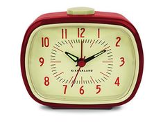 a red and white alarm clock on a white background