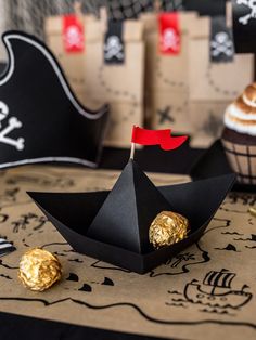 a pirate party with black paper boats and gold foiled chocolates