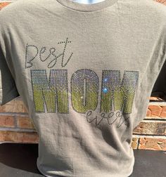 Best Mom Ever Rhinestone Bling T-shirt. Made to order by me with Quality Rhinestones (Cosmic Nite, Olive, and Olive AB). Military Green Tee. Shirt Information:  4.5 oz., 100% preshrunk ringspun cotton jersey. Modern Fit. Adult Unisex sizes up to 5x. Due to the nature of custom garments, we do not accept returns or exchanges unless there is a product defect. Please contact me with questions about sizing. Rhinestone Cotton Crew Neck T-shirt, Cotton Short Sleeve T-shirt With Rhinestones, Cotton T-shirt With Rhinestones And Short Sleeves, Cotton T-shirt With Rhinestones Short Sleeve, Green Tee Shirt, Bling Shirt, Bling Shirts, Green Tee, Best Mom Ever