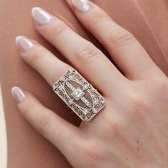 This exquisite Art Deco platinum and 18kt. yellow gold ring features a stunning 0.78ct transitional diamond at its center surrounded by 18 Old European Cut diamonds totaling 0.48ct. The ring has been expertly crafted to repurpose a vintage pin into an elegant estate ring. Ideal for special occasions, this unique jewelry piece showcases the beauty of bygone eras with perfect modernity. Size 6.25 Art Deco Pin Transformed into a ring Platinum 18kt. Yellow Gold 1pcs 0.78ct I/J VS2 in the center (tra Luxury White Diamond Ring With Single Cut Diamonds, Luxury White Single Cut Diamond Ring, Luxury Diamond Ring With Rose Cut Baguette Diamonds, Luxury Rose Cut Diamond Ring With Baguette Shape, Luxury Baguette Cut Diamond Ring With Rose Cut Diamonds, Luxury Baguette Cut Rose Cut Diamond Ring, Timeless Gold Diamond Ring In Platinum, Timeless Gold Diamond Ring With Platinum, Timeless Platinum Diamond Ring With Gold Color