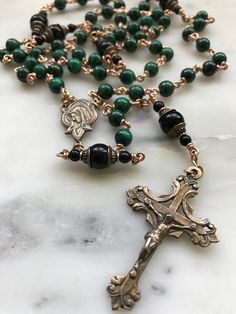 This rosary is handmade with 20 gauge bronze wire and chain, and bronze rosary medals. The stones are 6mm malachite gemstones and 8mm onyx gemstones. Spiritual Wire Wrapped Crucifix Jewelry, Handmade Bronze Spiritual Rosary, Handmade Spiritual Bronze Rosary, Handmade Bronze Rosary As A Gift, Spiritual Wire Wrapped Rosary As Gift, Spiritual Gift Wire Wrapped Rosary, Antique Handmade Rosary As Gift, Holy Spirit Dove, Custom Rosary