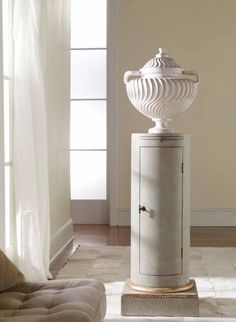 a white cabinet sitting in the middle of a living room