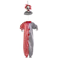 a clown with red hair and white makeup is hanging from a string in the air