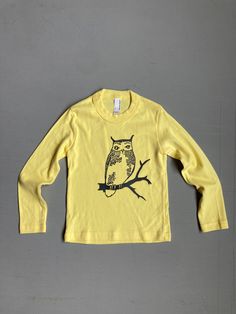 Cotton long sleeve tee or pajama top is hand printed with my owl design in grey ink on a yellow top. tee is from american apparel Yellow: 2T Yellow Printed T-shirt For Fall, Hand Printed Crew Neck Top With Relaxed Fit, Relaxed Fit Hand Printed Crew Neck Top, Hand Printed Cotton Graphic Tee, Yellow Graphic Tee For Fall, Yellow Cotton T-shirt For Fall, Yellow Long Sleeve T-shirt For Spring, Yellow Relaxed Fit Long Sleeve T-shirt, Long Sleeve Cotton T-shirt With Funny Print