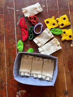 some felt pieces and scissors on a wooden table