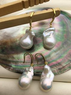 "This pearl is genuine freshwater pearl, 100% real pearl quantity: 1 pair metal: sterling silver  metal color: gold pearl luster: high++ pearl body: AA+ pearl shape: baroque pearl color: white,please look at picture pearl size: 14-16mm--width x20-28mm--length Back to Other Jewelry Section 01: \"Tahitian,Akoya,Sea Pearl\" Section: https://www.etsy.com/shop/WenPearls?section_id=15806339 02: \"Potato/Near Round Pearl\" Section: https://www.etsy.com/shop/WenPearls?section_id=16378067 03: \"Round Pearl\" Section: https://www.etsy.com/shop/WenPearls?section_id=16163245 04: \"Rice/Oval/Teardrop Pearl\" Section: https://www.etsy.com/shop/WenPearls?section_id=16190184 05: \"Nugget Pearl\" Section: https://www.etsy.com/shop/WenPearls?section_id=18893039 06: \"Button/Coin/Rondelle Pearl\" Section: ht White Baroque Pearl Earrings With High Luster, White Lustrous Baroque Pearl Earrings, White High Luster Baroque Pearl Earrings, White Baroque Pearl Earrings With Ear Wire, Leather Pearl Jewelry, Big Pearl, Gold Dangle Earrings, Pearl Leather, Sea Pearl