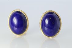 Beautiful and Unique Earrings. Coiled Cable outline around a Lapis Lazuli oval cabochon. 14k Gold. Yellow Gold Details: 12mm by 16mm lapis 4.9grams total Luxury Oval Cabochon Gemstone Earrings, Oval Yellow Gold Cabochons For Formal Events, Classic Blue Cabochons For Formal Occasion, Blue Classic Cabochons For Formal Occasion, Blue Classic Formal Cabochons, Blue Formal Classic Cabochons, Classic Blue Gemstone Cabochons, Blue Cabochon Earrings For Formal Occasions, Elegant Blue Oval Cabochon Earrings