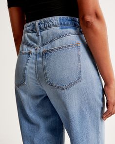 Our Curve Love high rise cropped wide leg jeans in a medium wash with a raw-cut hem. This fit features a 10.5” high rise, is relaxed at the waist and hips, and eases into a wide, full-length leg shape with a cropped length. Our Curve Love styles add an additional 2” at the hip and thigh to allow room for your curves and eliminate waist gap. This jean is made from our super light drapey denim fabric, which features a super soft lightweight rigid denim. Mom Fit Dark Wash Cropped Jeans With Frayed Hem, Spring Cropped Mom Jeans With Frayed Hem, Spring Mom Fit Cropped Jeans With Frayed Hem, Everyday High Waist Cropped Jeans With Frayed Hem, Medium Wash Mom Fit Cropped Bottoms, Medium Wash Cropped Leg Mom Fit Bottoms, Everyday Medium Wash Cropped Jeans, Medium Wash Cropped Mom Jeans, Medium Wash Mom Fit Cropped Jeans