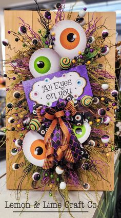 an orange and purple halloween card with eyes on it's front, the words all eyes on you