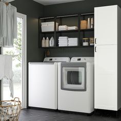 a washer and dryer sitting in a room next to a door with open shelves