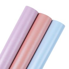 three different colored yoga mats stacked on top of each other, one in blue and the other in pink