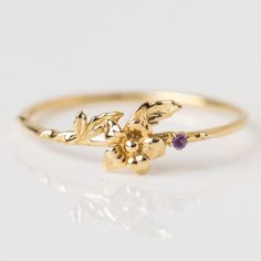 Our birth flower ring collection is a way to celebrate your growth each year. Like a flower, nurture yourself and watch as you grow. This Solid Gold Birth Flower Ring features a detailed yet delicate bloom set with a natural gem in each month's birthstone. The perfect piece for gifting, both to others and yourself. Natural gemstones 1mm 9k solid yellow gold Band width 1.1 mm Family Gold is a Local Eclectic exclusive. January: Carnation & Garnet February: Iris & Amethyst March: Daffodil & January Carnation, Affordable Fine Jewelry, Flower Rings, Local Eclectic, Birth Month Flower, Black Jewelry, Birth Flower, Gold Plated Rings, Gold Collection