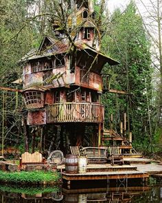 an old wooden house sitting on top of a body of water