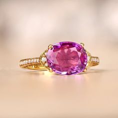 This item has just been reserved by another customer. Please contact us to be notified if it becomes available.  This beautiful Pink sapphire ring is made of shiny yellow gold. The ring has a beautiful Pink sapphire gemstone in an oval shape. The Pink sapphire weighs about 2.73 carats and is held securely in place by small metal prongs. On the sides of the ring, there are tiny round diamonds that add extra sparkle.  This Pink sapphire ring is a diamond set closely together along the side of the Vintage Diamond Earrings, Estate Diamond Jewelry, Colored Diamond Rings, Edwardian Jewelry, Pink Sapphire Ring, Sapphire And Diamond Ring, Fancy Diamonds, Antique Necklace, 18k Yellow Gold Ring