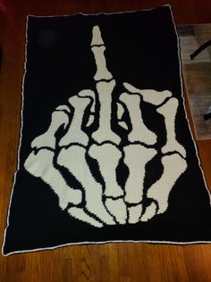 a black and white knitted blanket with a hand on it