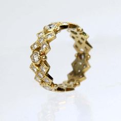 a yellow gold ring with diamonds on it