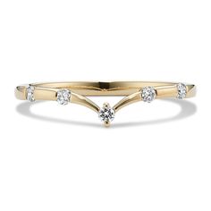 a yellow gold ring with three diamonds