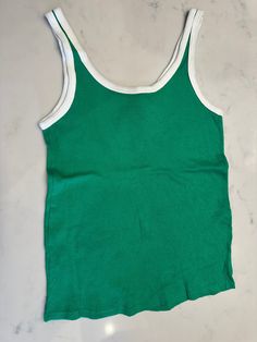 Cotton stretch knit tank top in green. 70s white rib knit crewneck and armscye. Size fits medium. Retro Green Sleeveless Tank Top, Retro Fitted Crew Neck Tank Top, Fitted Retro Crew Neck Tank Top, Retro Green Sleeveless Top, Fitted Green Cotton Tank Top, Ribbed Green Tank Top For Spring, Spring Green Ribbed Tank Top, Green Scoop Neck Tank Top For Everyday, Everyday Green Scoop Neck Tank Top