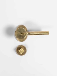 two brass door knobs on a white background