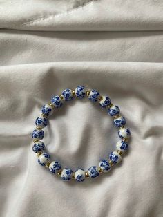 This elegant blue and white flowered ceramic bracelet brings color and style to go with any bracelet or watch you have on Casual Blue Flower-shaped Beaded Bracelets, Blue Floral Print Flower-shaped Jewelry, Casual White Flower Shaped Stretch Bracelet, Casual White Flower Stretch Bracelet, Blue Bead Bracelet Ideas, Blue Pottery Designs, Ceramic Beads Bracelet, Ceramic Bracelet, White Beads Bracelet