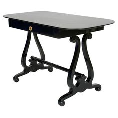 a black table with wheels on it and a white background in the backround