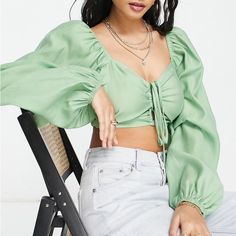 Cropped, Captivating And Ideal With Your High-Waist Styles, This Top Features A Sweetheart Neck With A Ruched Center Cutout And Halter Ties. Sweetheart Neck Long Sleeves 82% Lyocell, 18% Polyester Trendy Ruched Blouse, Trendy Ruched Day Out Blouse, Trendy Ruched Blouse For Day Out, Casual Ruched Crop Top For Spring, Long Sleeve Ruched Crop Top For Summer, Ruched Crop Top For Spring Vacation, Spring Green Ruched Blouse, Green Ruched Blouse For Summer, Trendy Ruched Tops For Spring