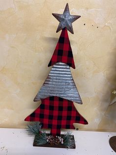 a metal christmas tree sitting on top of a table