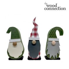 three wooden gnomes are standing in the same direction