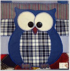 an owl is sitting on a patchwork quilt