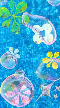 some bubbles floating in the water with flowers and leaves