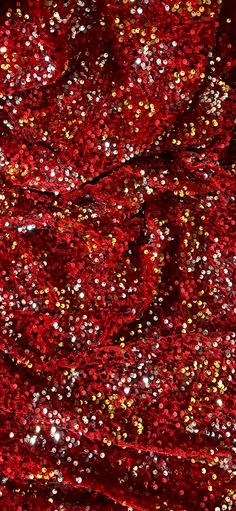 red and gold sequins are scattered on the surface