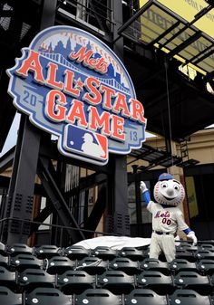 a mascot stands in front of the all star game sign