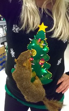 a woman is holding a stuffed animal in front of a christmas tree t - shirt