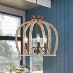 a light fixture hanging from the ceiling in a room with blue walls and wooden floors