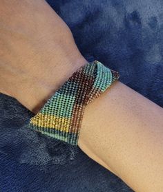 Herringbone stitch woven beaded bracelet in a random bohemian style. This one of a kind bracelet features earthy tones with deep gold accents. Herringbone Stitch, Wedding Gift Baskets, Braided Bracelets, Earthy Tones, Gold Accents, Beaded Bracelet, Herringbone, Bohemian Style, Aurora