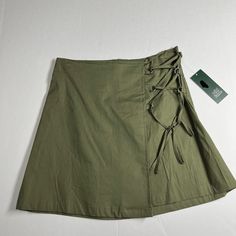 Wild Fable Skirt, Sie Xs, Olive Green In Color, Zipper And Hook And Eye In The Back, The String In The Front Is For Decorations Only, From The Waist Line To The Bottom Of The Skirt Is 15 Inches. Who What Wear Size Xl Color Lite Purple With Floral Print Long Sleeves With Elastic At Cuff Same Day Or Next Business Day Shipping, From A Nonsmoking Home, All Offers Are Welcome. Bundle With Other Items For A Discounted Price. Casual Cotton Wrap Skirt In Relaxed Fit, Summer Cotton Cargo Skirt, Cotton Cargo Skirt For Summer, Casual Cotton Wrap Skirt, Casual Cotton Wrap Skirt With Lining, Casual Relaxed Mini Wrap Skirt, Casual Green Relaxed Wrap Skirt, Casual Mini Wrap Skirt, Casual Flared Cargo Skirt For Summer