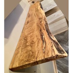 a wooden bench sitting on top of a hard wood floor