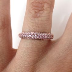 The three-row domed band is the perfect complement to any engagement ring. Wear alone, stack multiple, or pair it with any ring. This gorgeous light pink sapphire band features three rows of pave set 1.15 carats total weight circling all the way around, crafted in solid 18k rose gold. *Based on Ring size: 6.5 *Metal: Solid 18k Rose Gold *Weight: 3.05 grams *Stones: Natural Light Pink Sapphires *Stone Count: 135 PCS *Weight: 1.15 Carats Total *Band Measures: 3.5mm wide X 1.9mm thick (with +/- 0.1 Pink Pave Set Round Cut Ring, Pink Eternity Band Promise Ring Fine Jewelry, Pink Eternity Band For Promise Ring, Fine Jewelry Pink Round Cut Eternity Band, Fine Jewelry Rose Gold Stackable Rings With Pave Setting, Pink Diamond Half Eternity Band, Luxury Pink Half Eternity Rings, Pink Fine Jewelry Eternity Band For Promise, Pink Half Eternity Diamond Band