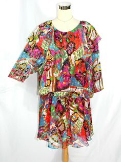 Stunning vintage 1980's blouson dress from Linda Caputo in a bright, bold, abstract pattern in just about every color imaginable. ~Kerchief collar ~Moderate shoulder pads ~3/4 sleeves ~Ruched elastic waist, best worn dropped-waist style ~Sheer chiffon overlay with red lining on torso and skirt ~No fasteners, slips over the head There is no " ingredients" tag so I am only guessing that it's made of polyester. It feels smooth and light. There is also no size tag so please see measurements below. I Drop Waist Dress Pattern, Bad Reputation, Drop Waist Dress, Chiffon Overlay, Blouson Dress, Fabulous Dresses, Dropwaist Dress, Sheer Chiffon, Best Wear