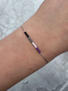 a woman's arm with a bracelet on it that has a purple and white tube attached to it