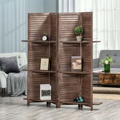 a room divider made out of wood with shutters on the sides and shelves