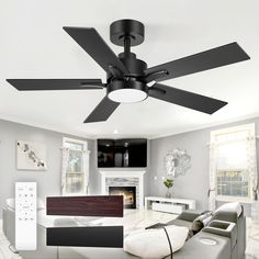 a ceiling fan in a living room with white walls and floor tiles on the floor