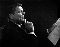 a black and white photo of a man reading a book