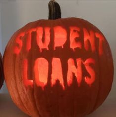 two pumpkins with the words student loan carved on them