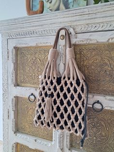 a purse hanging on the side of a cabinet